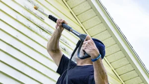 Pressure washing a home before painting