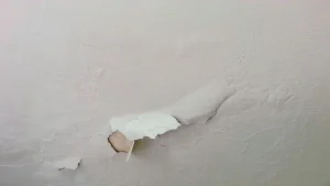 Peeling paint on a humid bathroom wall