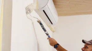 Painting trim around a window AC unit