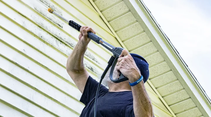 Pressure washing a home before painting