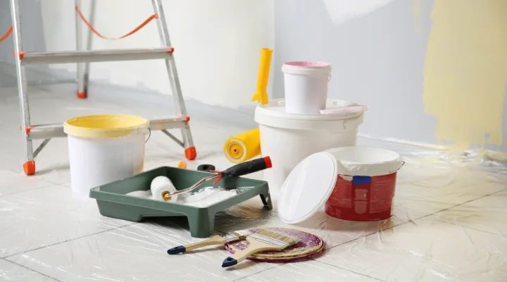 Plastic sheeting and painter’s tape protecting floors, and landscaping during exterior paint job